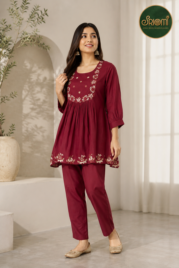 Women's embroidered cambric and mal cotton kurta pant set in maroon for office wear